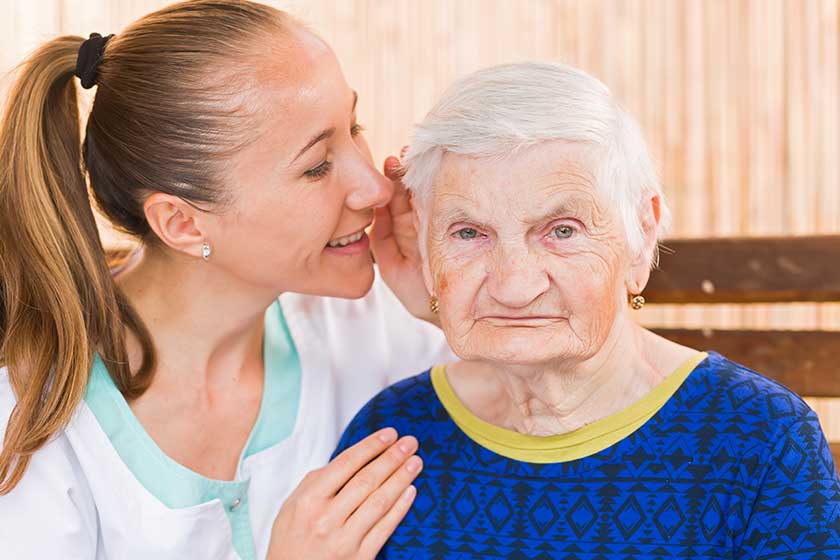 Elderly woman with caregiver