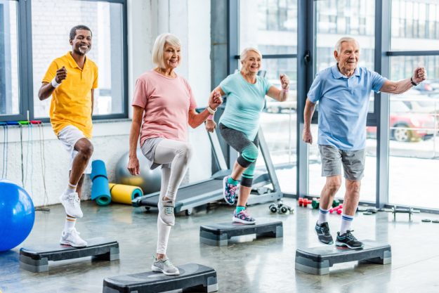 smiling multiethnic senior athletes synchronous exercising on st Best Activities For Seniors With Parkinson's Disease