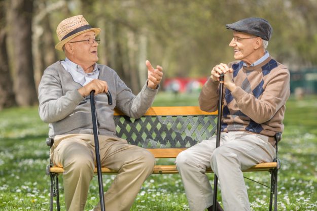 Two seniors talking to each other in park How To Reconnect with Your Old Friends