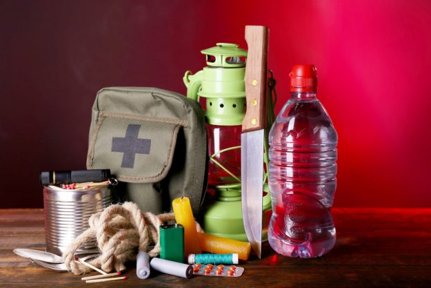 Emergency preparation equipment on wooden table, on dark background flood-in-york-pa-what-to-include-in-a-disaster-preparedness-kit-for-seniors