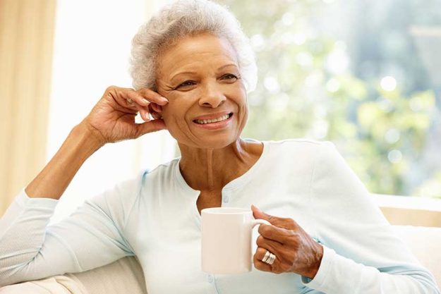 Senior woman relaxing with cup of coffee Senior woman relaxing with cup of coffee