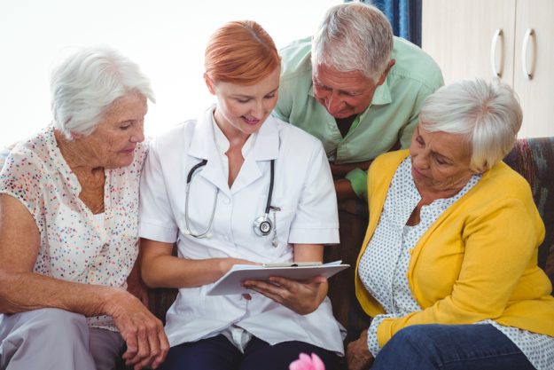 Retired person looking at a notebook on a sofa 5 Ways Memory Care In Leitersburg, MD Helps Dementia Patients Prepare For A Medical Visit