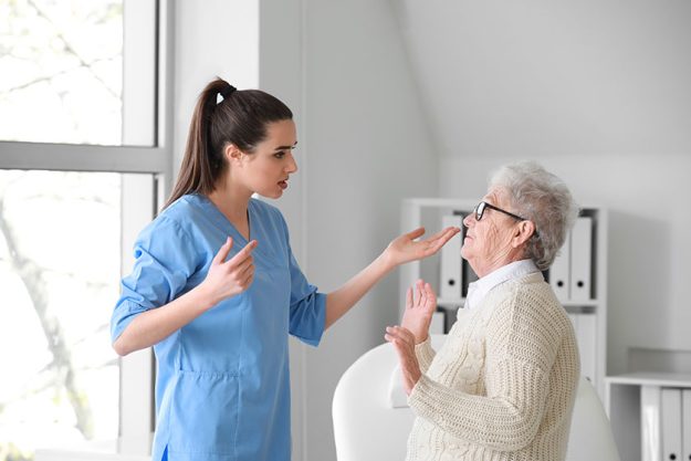 Medical worker mistreating senior woman in nursing home