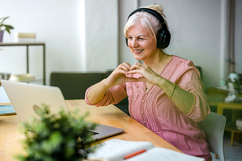 Senior woman forming a heart with her hands