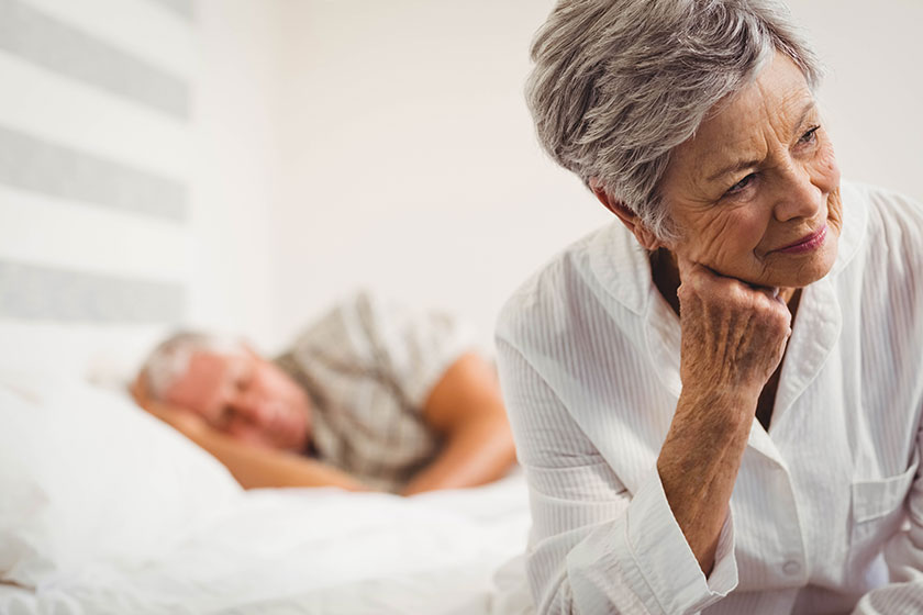 Worried senior woman sitting on bed Worried senior woman sitting on bed