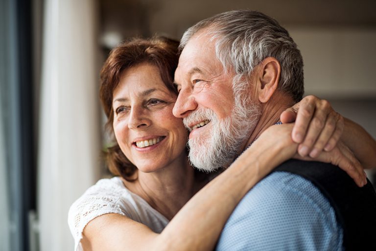 A senior couple indoors at home