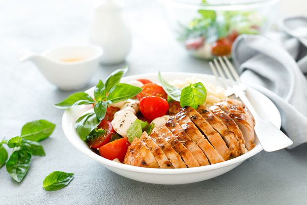 Grilled chicken lunch bowl with orange juice