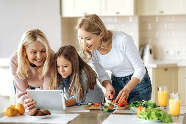 Happy mom daughter granddaughter cooking together