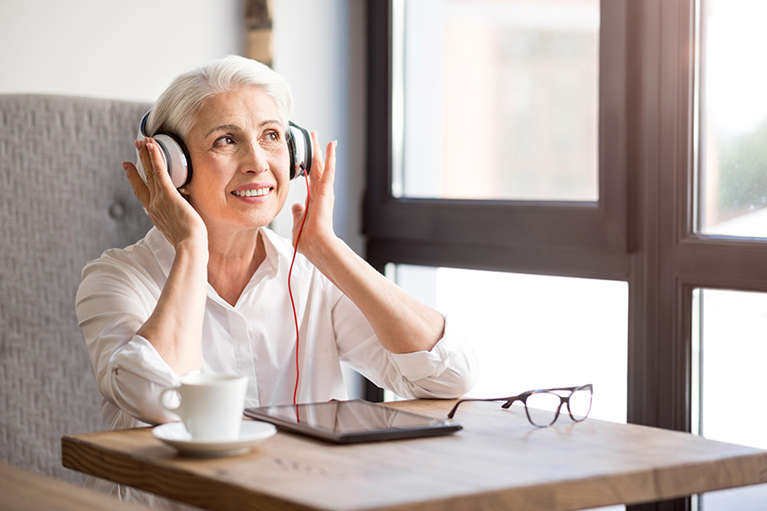 Positive senior woman listening to music