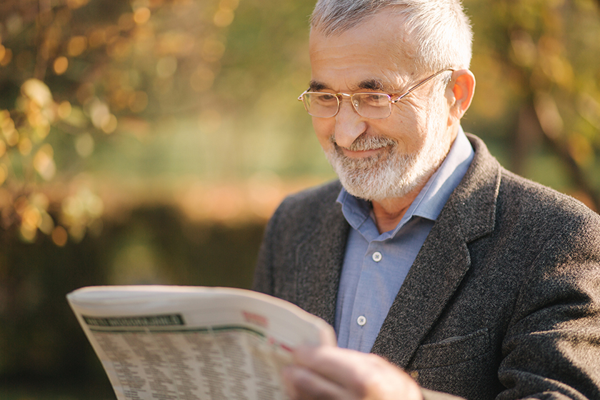 Senior man read a newspaper in the park