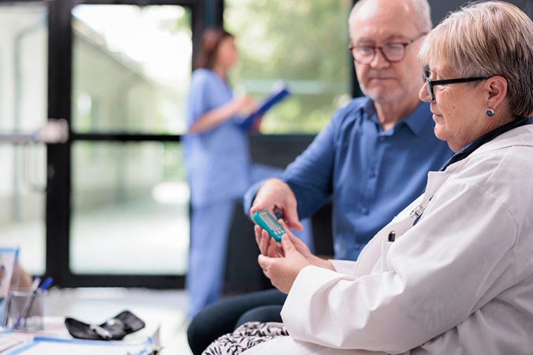 Senior medic taking patient insulin level test