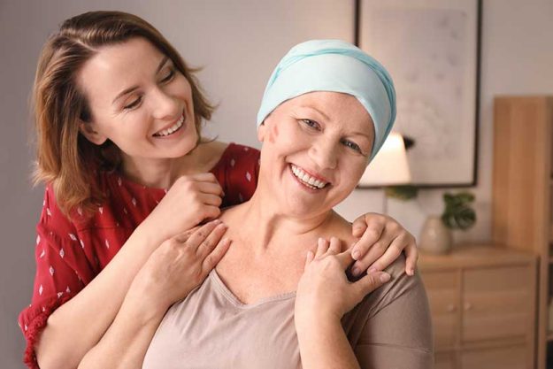 Young woman visiting her mother with cancer indoors