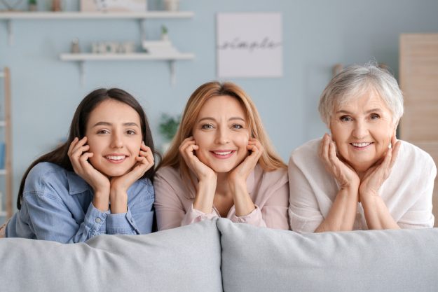 Mature woman with her adult daughter and mother spending time together at home Mature woman with her adult daughter and mother spending time together at home