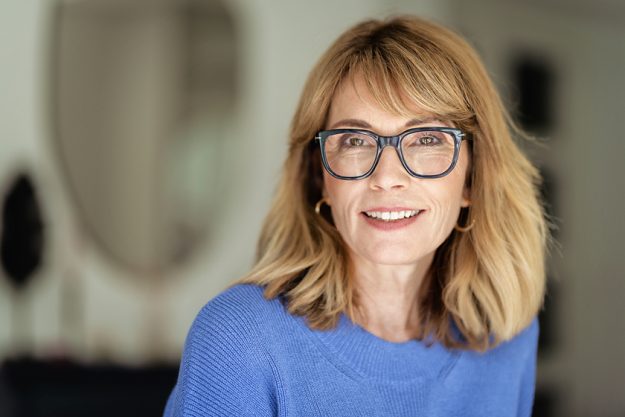 Close-up portrait of a mid aged blond haired woman standing at t Close-up portrait of a mid aged blond haired woman standing at t