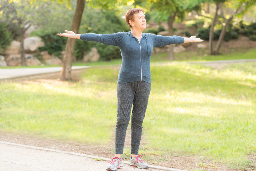 Elderly beautiful active happy woman in the morning in the autumn park doing sports exercises. Elderly beautiful active happy woman in the morning in the autumn park doing sports exercises.