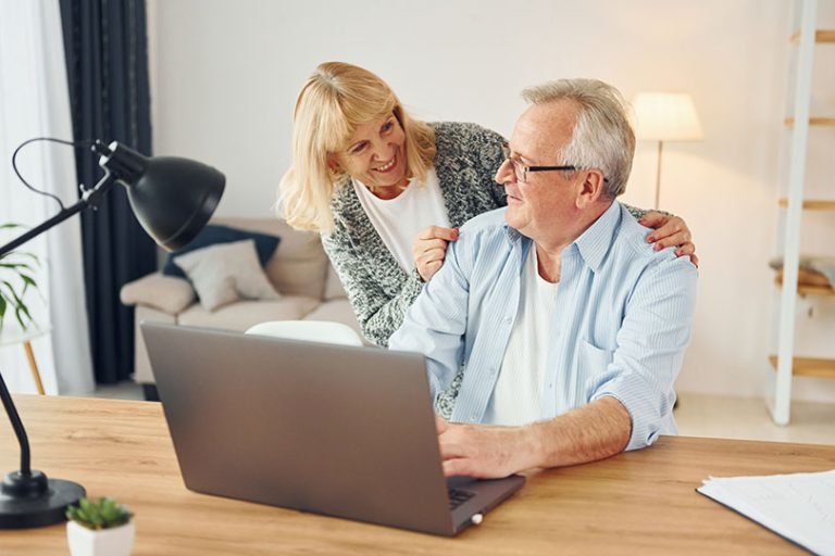 Using laptop. Senior man and woman is together