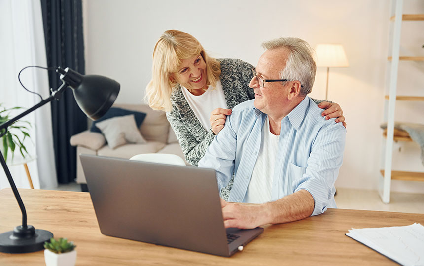 Using laptop. Senior man and woman is together