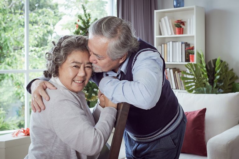 Happy couple old elderly senior man woman hugging touch forehead
