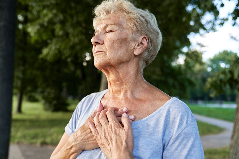 Calm senior woman doing breathing exercise Calm senior woman doing breathing exercise