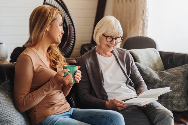 Middle aged woman spending time with her senior mother at home