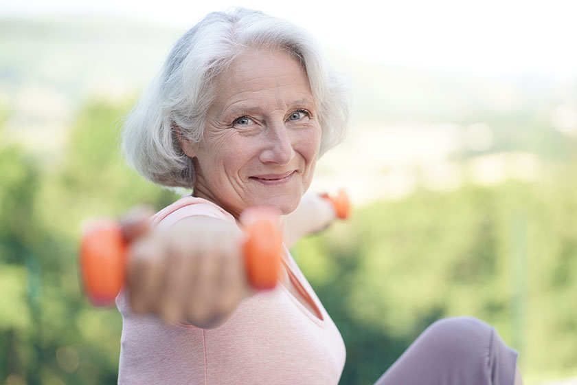 Portrait of smiling senior woman with white hair doing fitness exercises outside Portrait of smiling senior woman with white hair doing fitness exercises outside