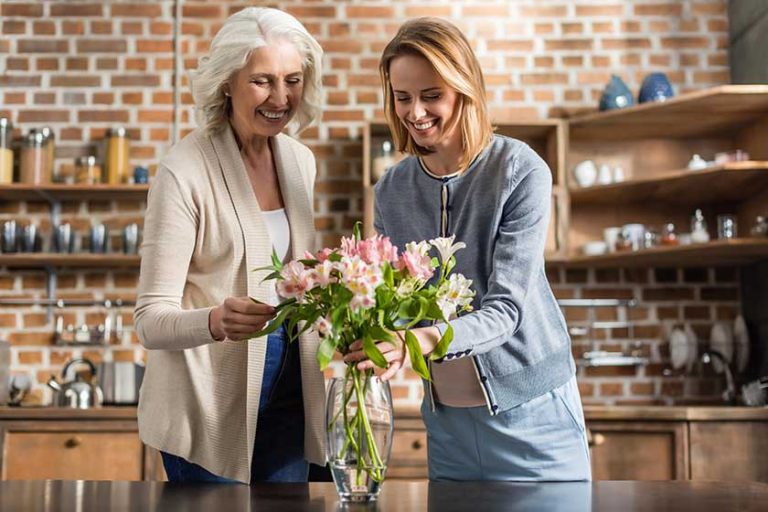 Pregnant woman and her mother on kitchen