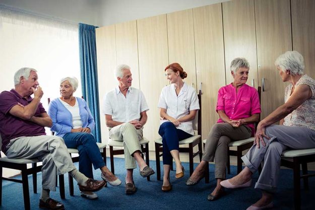 Seniors interacting with nurse