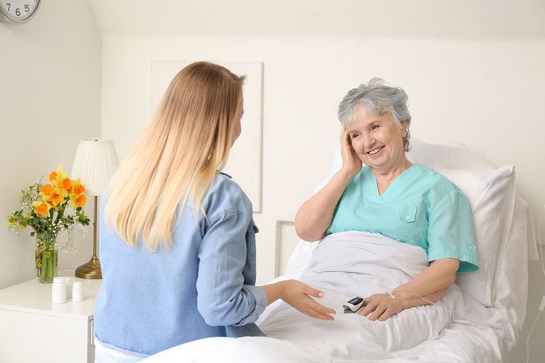 Young woman visiting her grandmother in hospital