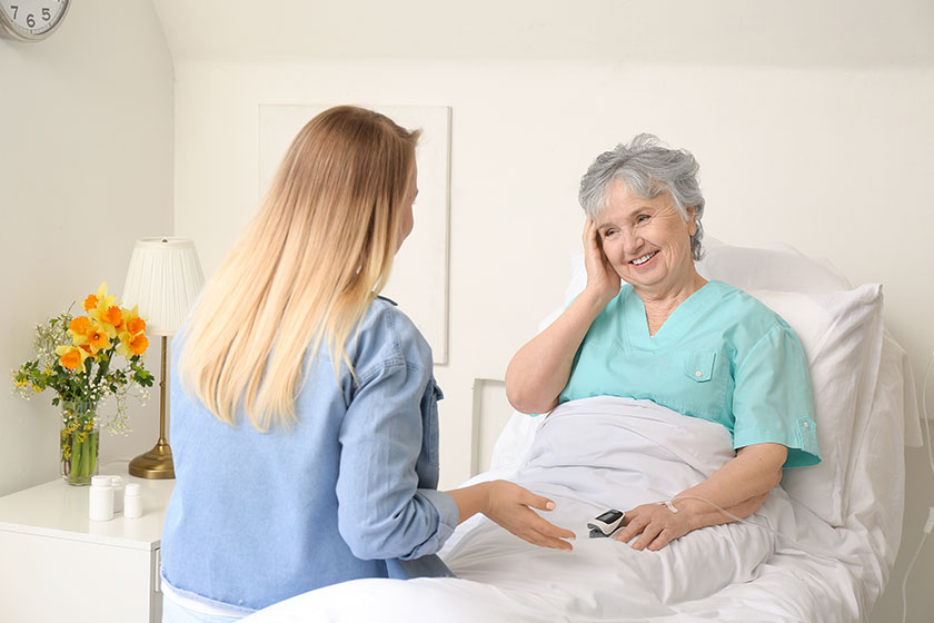 Young woman visiting her grandmother in hospital Young woman visiting her grandmother in hospital
