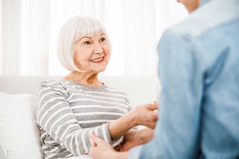 Remove BG Save Share Sample Cheerful elderly woman lying in bed at home