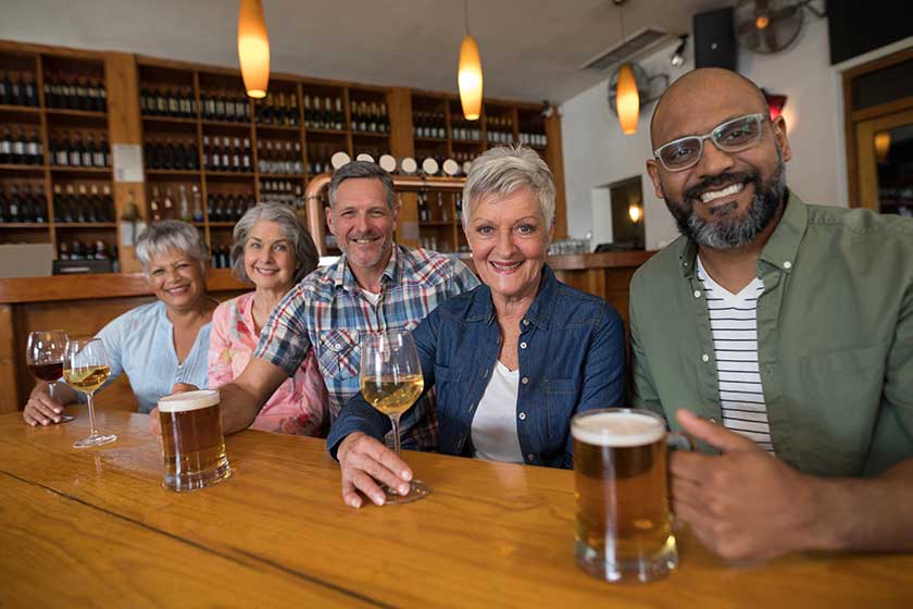 Happy friends having drinks in bar