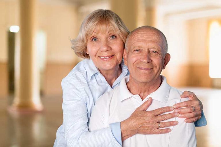 Happy senior couple smiling at home