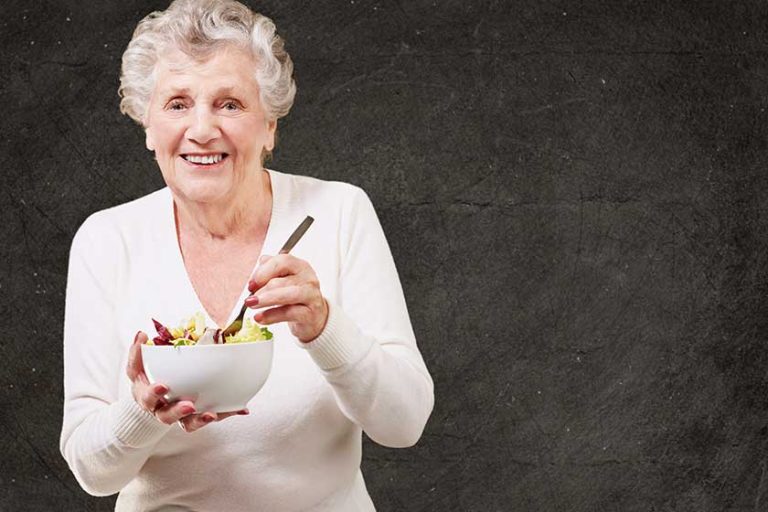 senior woman eating salad