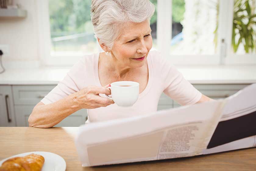 Senior woman reading newspaper Senior woman reading newspaper