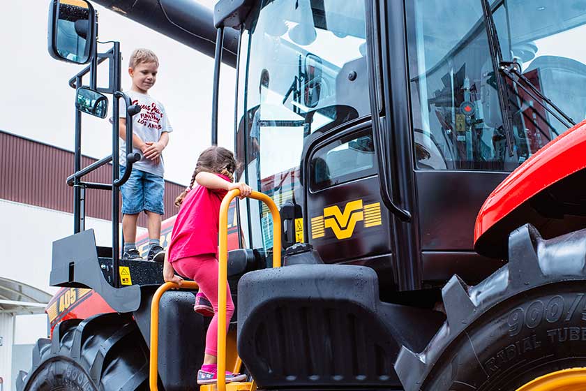 10.2019 Slovakia .Nitra.Children visiting a huge tractor. Tractor Great for agriculture at the show. 10.2019 Slovakia .Nitra.Children visiting a huge tractor. Tractor Great for agriculture at the show.