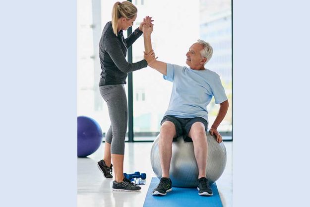 We want to focus on the elbow. Full length shot of a friendly physiotherapist helping her senior patient stretch in a fitness centre We want to focus on the elbow. Full length shot of a friendly physiotherapist helping her senior patient stretch in a fitness centre