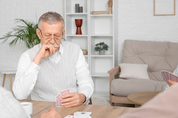 Elderly-man-playing-cards-at-home