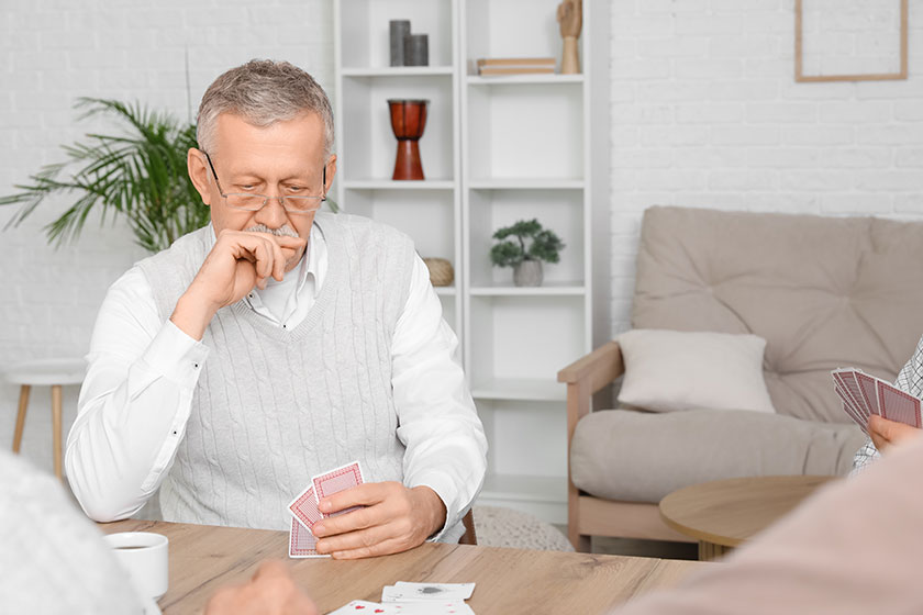 Elderly-man-playing-cards-at-home