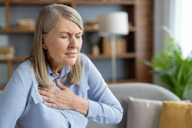Mature-woman-experiencing-discomfort-and-holding-her-chest Mature-woman-experiencing-discomfort-and-holding-her-chest