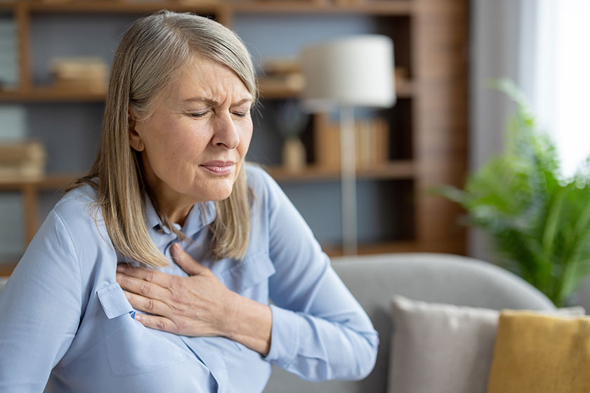 Mature-woman-experiencing-discomfort-and-holding-her-chest