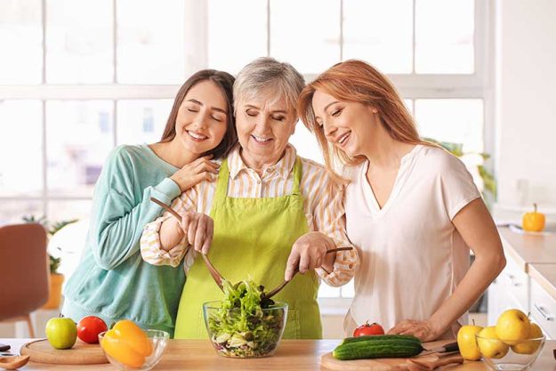 Mature-woman-with-her-adult-daughter-and-mother-cooking