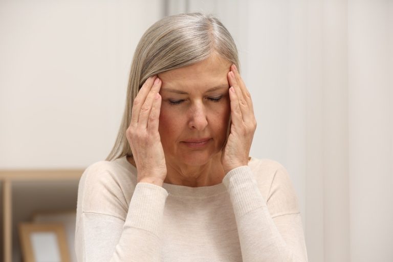 Menopause. Woman suffering from headache at home — Photo