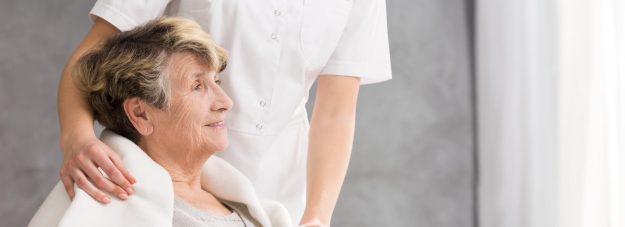 Nurse,Standing,Behind,The,Senior,Woman,Looking,At,The,Bright
