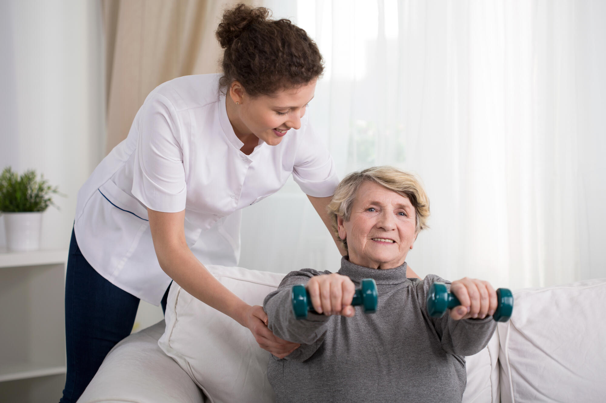 Old,Woman,Training,With,Physiotherapist,At,Home