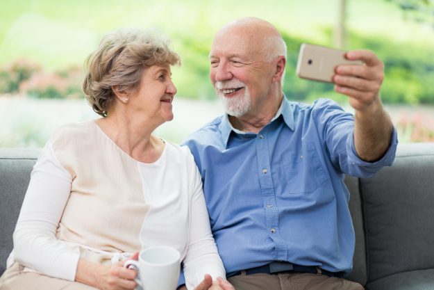 Cute,Senior,Couple,Taking,Selfie,At,Home,For,Social,Media