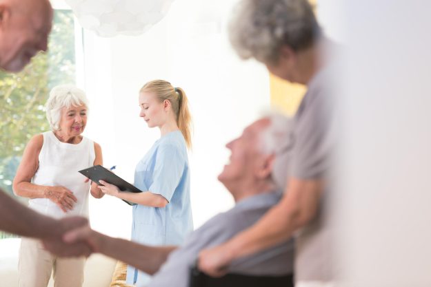 Nurse,Sharing,Health,Information,With,Senior,Patient,While,Standing,In
