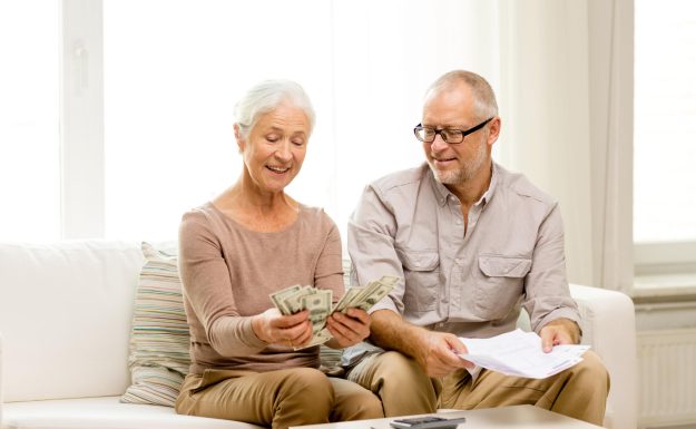 Senior,Couple,With,Money,And,Calculator,At,Home