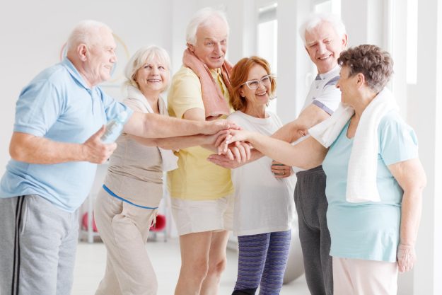 Team,Of,Happy,Active,Seniors,Gathering,Hands,Together,Before,The