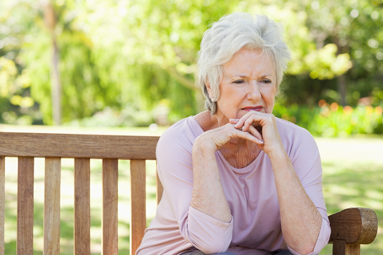 woman-serious-expression-sitting-bench