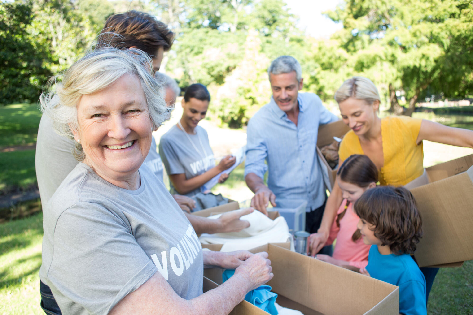 Happy,Volunteer,Family,Separating,Donations,Stuffs,On,A,Sunny,Day